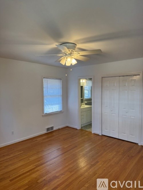 A room with wooden floors and a ceiling fan.