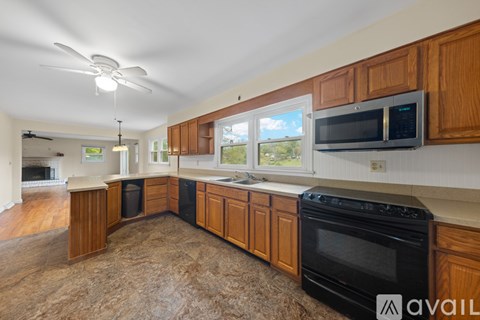 A kitchen with wooden cabinets and a black oven.