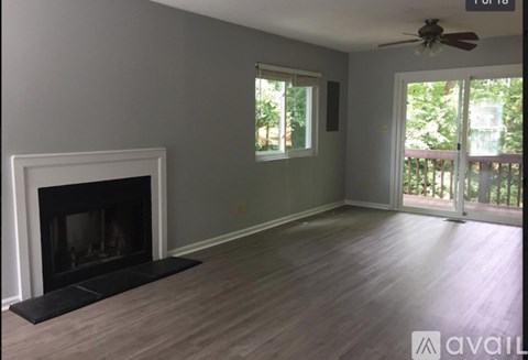 A room with a fireplace and sliding glass doors.