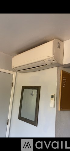 A wall-mounted air conditioner is installed above a door.