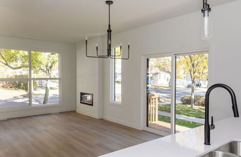 A modern kitchen with a large island and a fireplace.