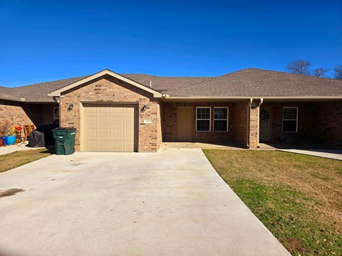 A house with a brown roof and a garage door.