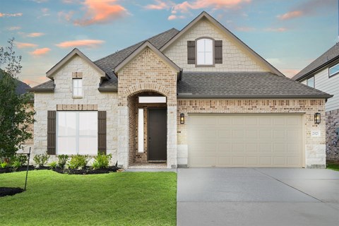 A house with a garage door and a driveway.