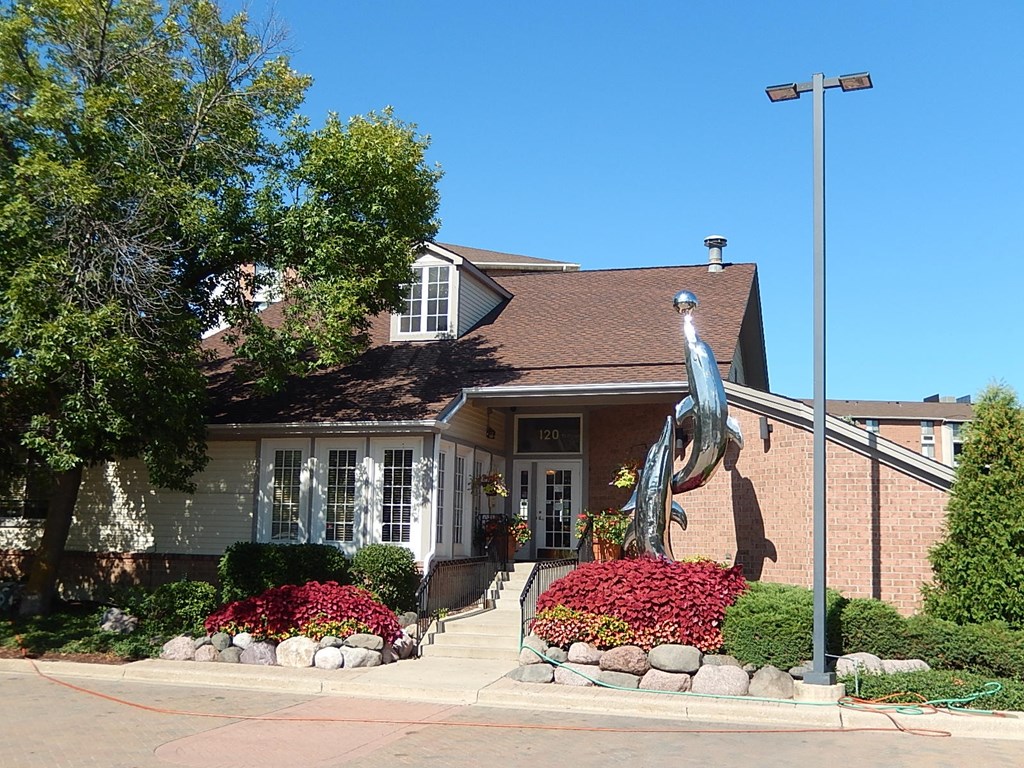 A house numbered 120 with a statue of a fish in front.