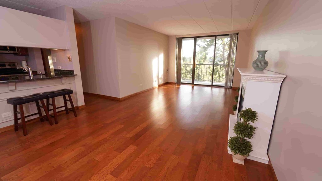 A room with wooden floors and a fireplace.