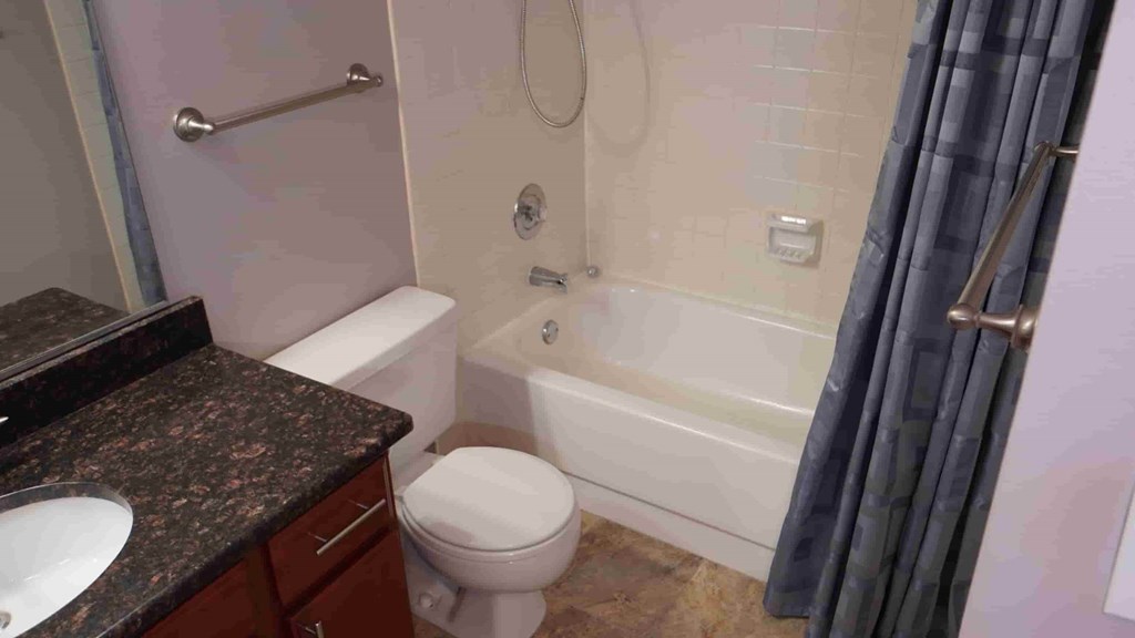A bathroom with a toilet, sink, and bathtub.