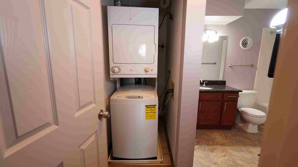 A small room with a water heater and a toilet.