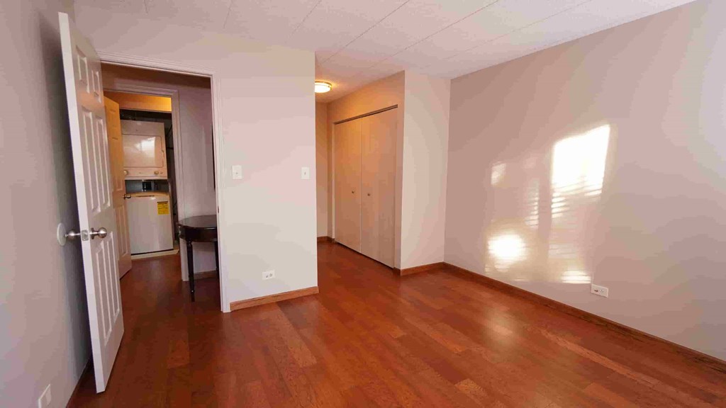 A room with wooden floors and white walls.