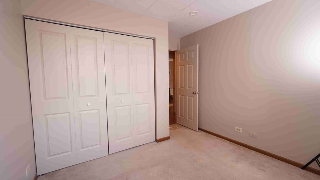 A room with a white door and a brown door.