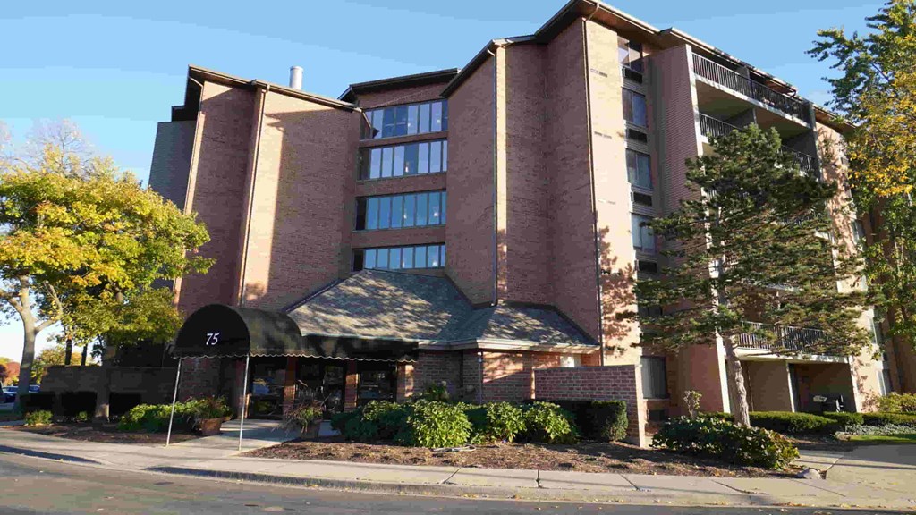 A large building with a black awning and the number 73 on it.