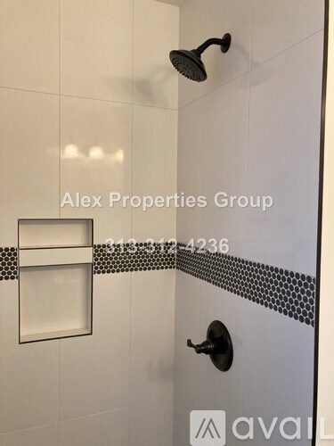 A shower area with a glass door and a wall-mounted shower head.