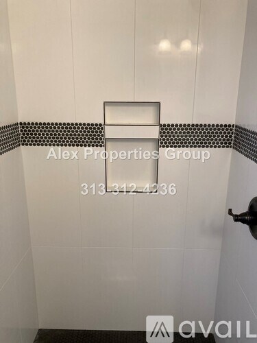 A white bathroom with a black and white tile border.