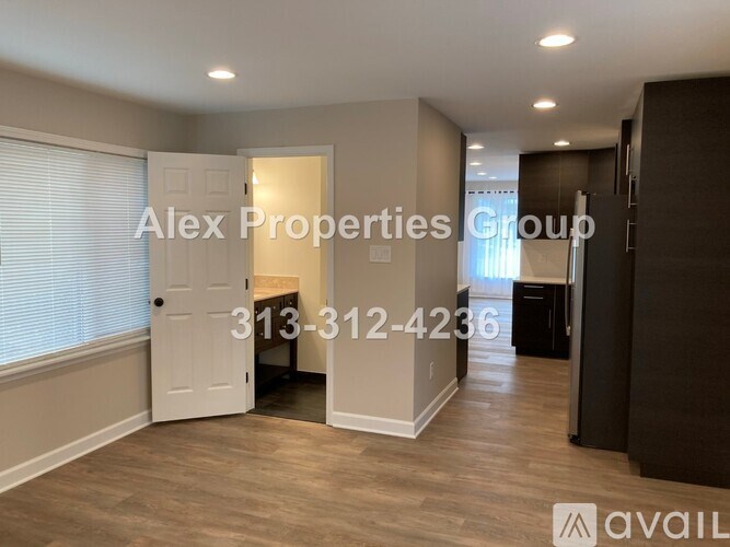 A room with a door and a window with blinds, and a phone number for Alex Properties Group.