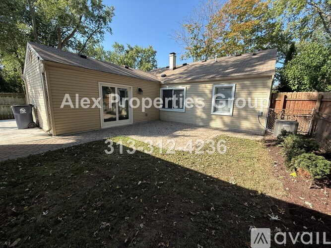 A house with a sign that says Alex Properties Group.
