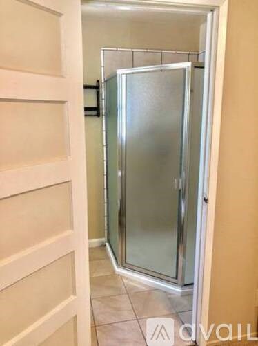 A white door with a glass panel is open.