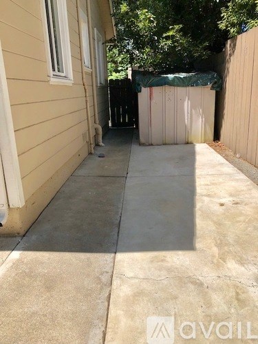 A concrete patio area in front of a house.