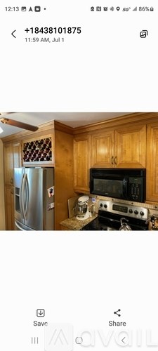 A kitchen with wooden cabinets and a stainless steel refrigerator.