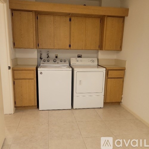 A kitchen with a white washer and dryer.