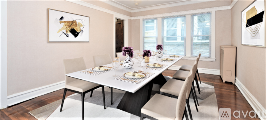 A dining room with a white table and chairs.