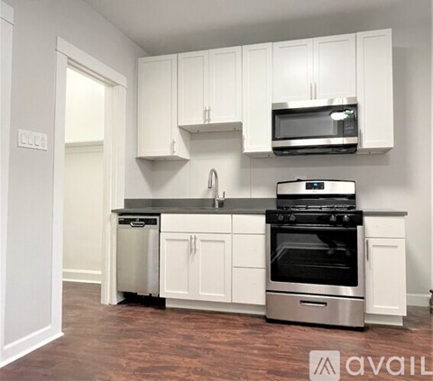 A kitchen with white cabinets and stainless steel appliances.