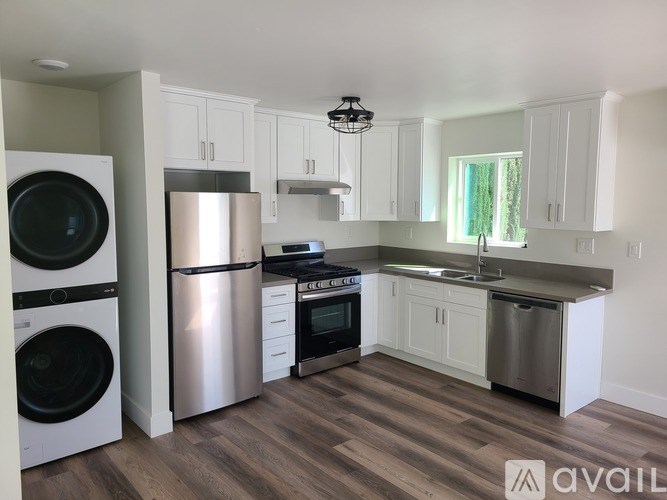 A kitchen with white cabinets and stainless steel appliances.
