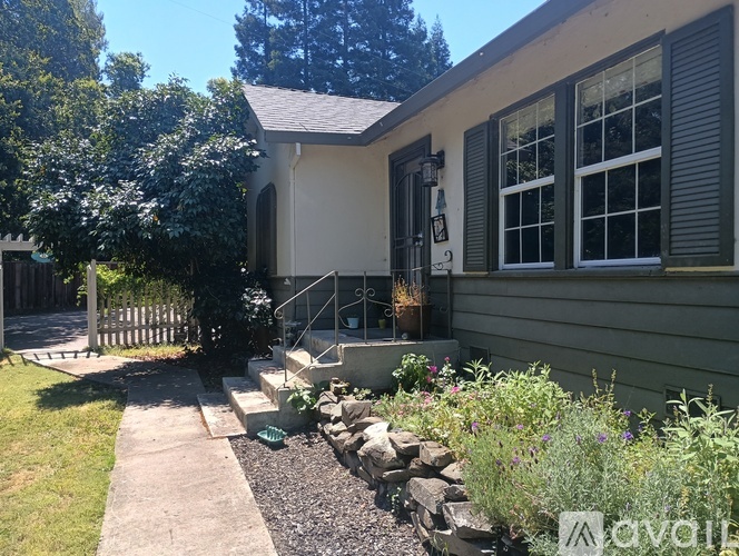 A house with a grey front door and a small porch.