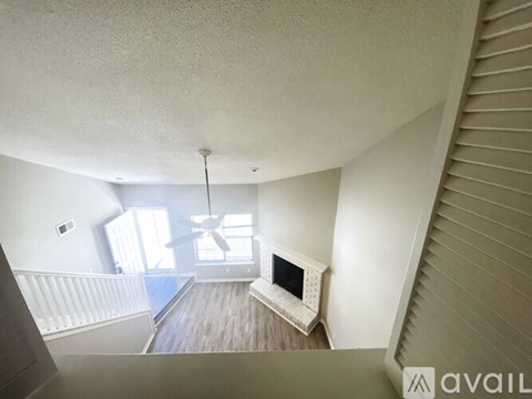 A living room with a white couch and a television.