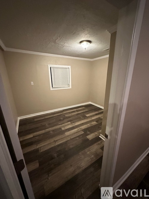 A room with wooden stairs leading to a window.