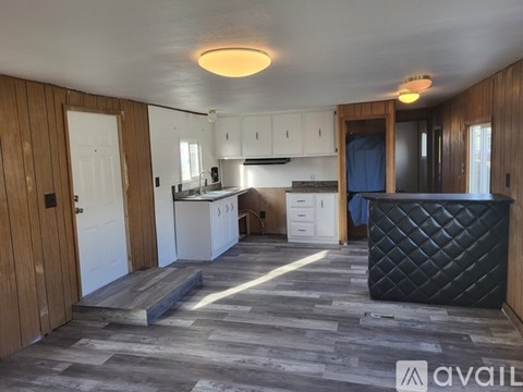 A kitchen with wooden cabinets and a black countertop.
