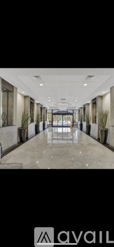 A long hallway with a tiled floor and white walls.