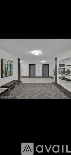 A hallway with a bench and a painting on the wall.