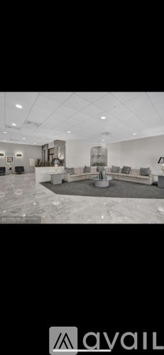 A spacious living room with a large sofa set and a coffee table.