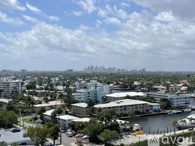 A cityscape with buildings and a body of water.