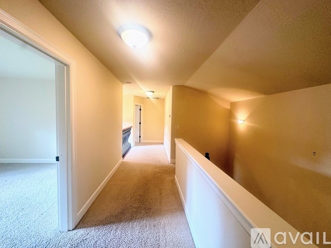 A room with a window and a carpeted floor.