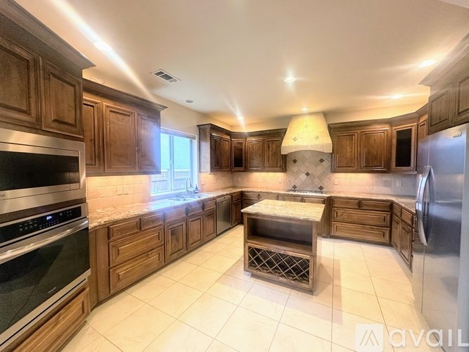 A chandelier with a circular design is hanging from the ceiling.