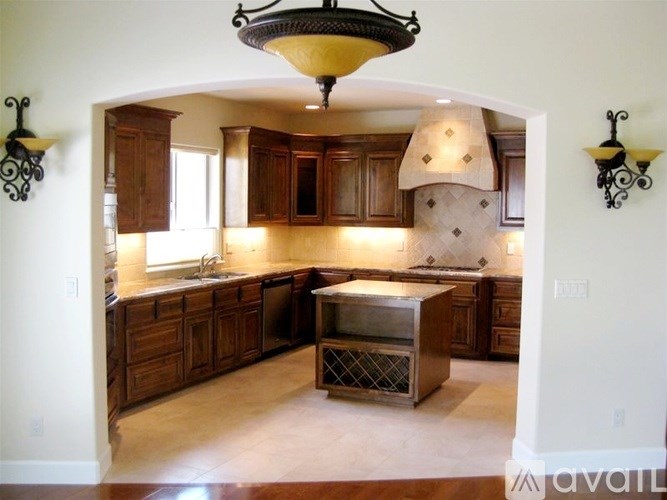 A kitchen with wooden cabinets and a central island.