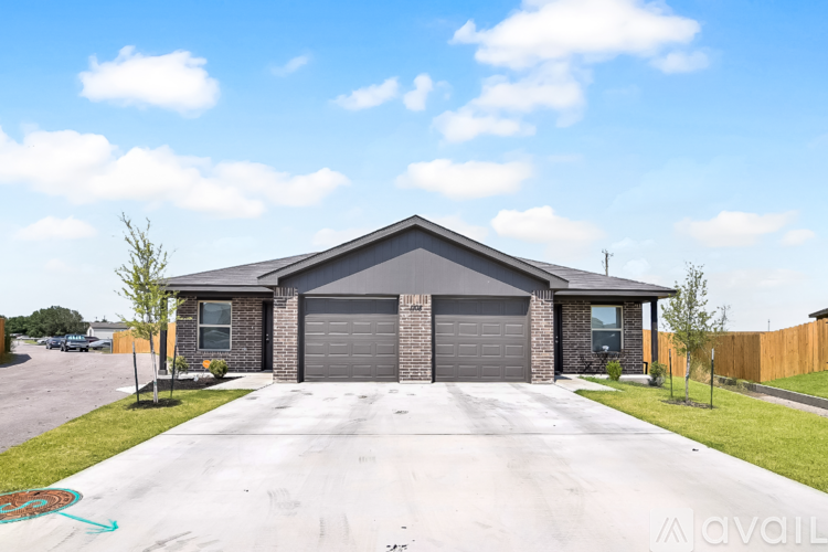 A house with a grey garage door is for sale.