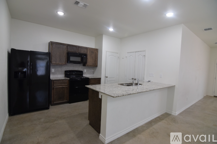 A kitchen with black appliances and a white countertop.