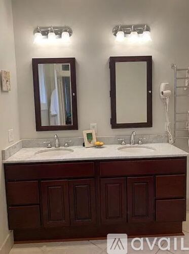 A bathroom with a vanity and two sinks.