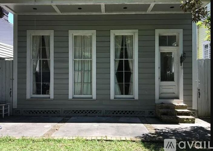 A house with three windows and a door is available for rent.