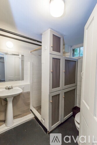 A bathroom with a sink, toilet and shower.