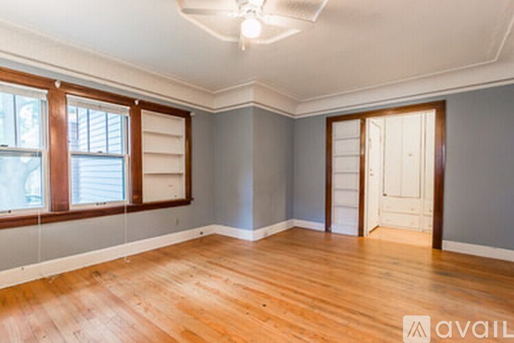 A room with wooden floors and a white ceiling with a light fixture.