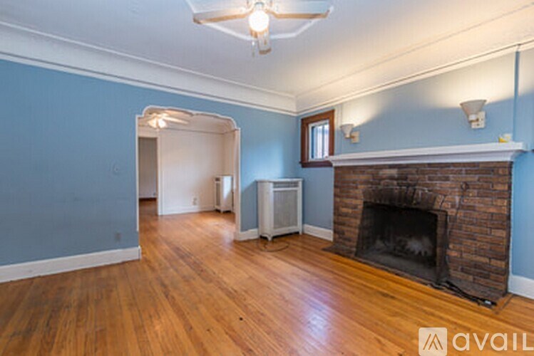 A room with a fireplace and a wooden floor.