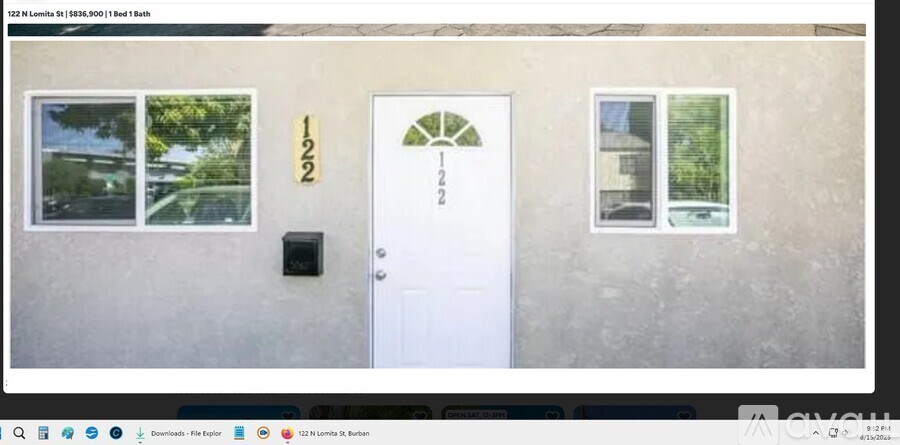 A white door with a black mailbox is on the front of a house.