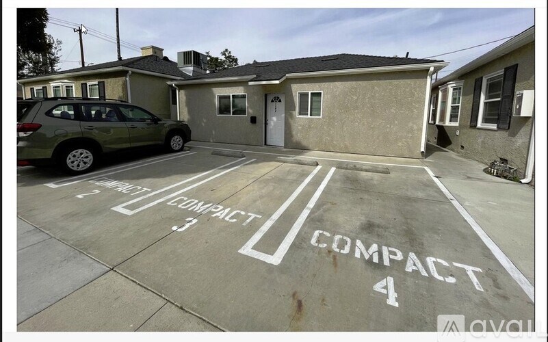 A parking lot with a compact 4 sign painted on the pavement.