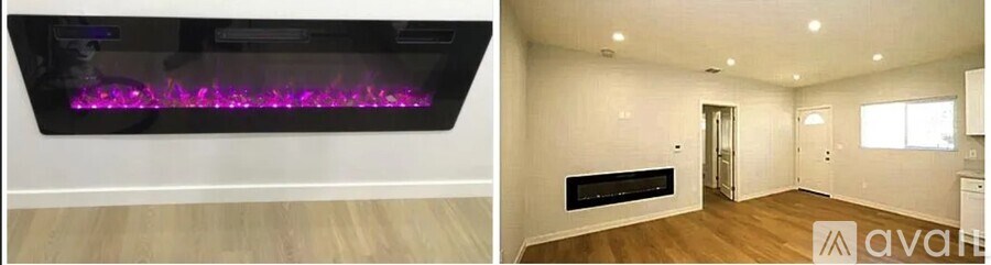 A modern living room with a purple flame wall light and a black fireplace.