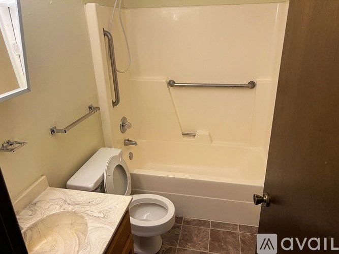 A bathroom with a toilet, sink, and bathtub.