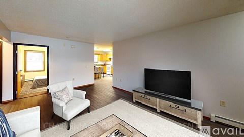 A living room with a white couch and a television.