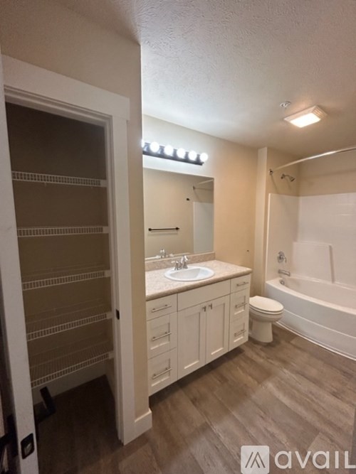A bathroom with a sink, toilet, and bathtub.
