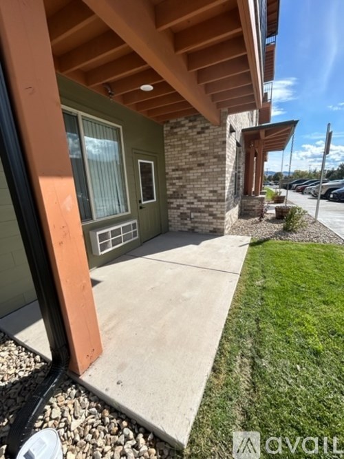 A building with a green wall and a brown roof.
